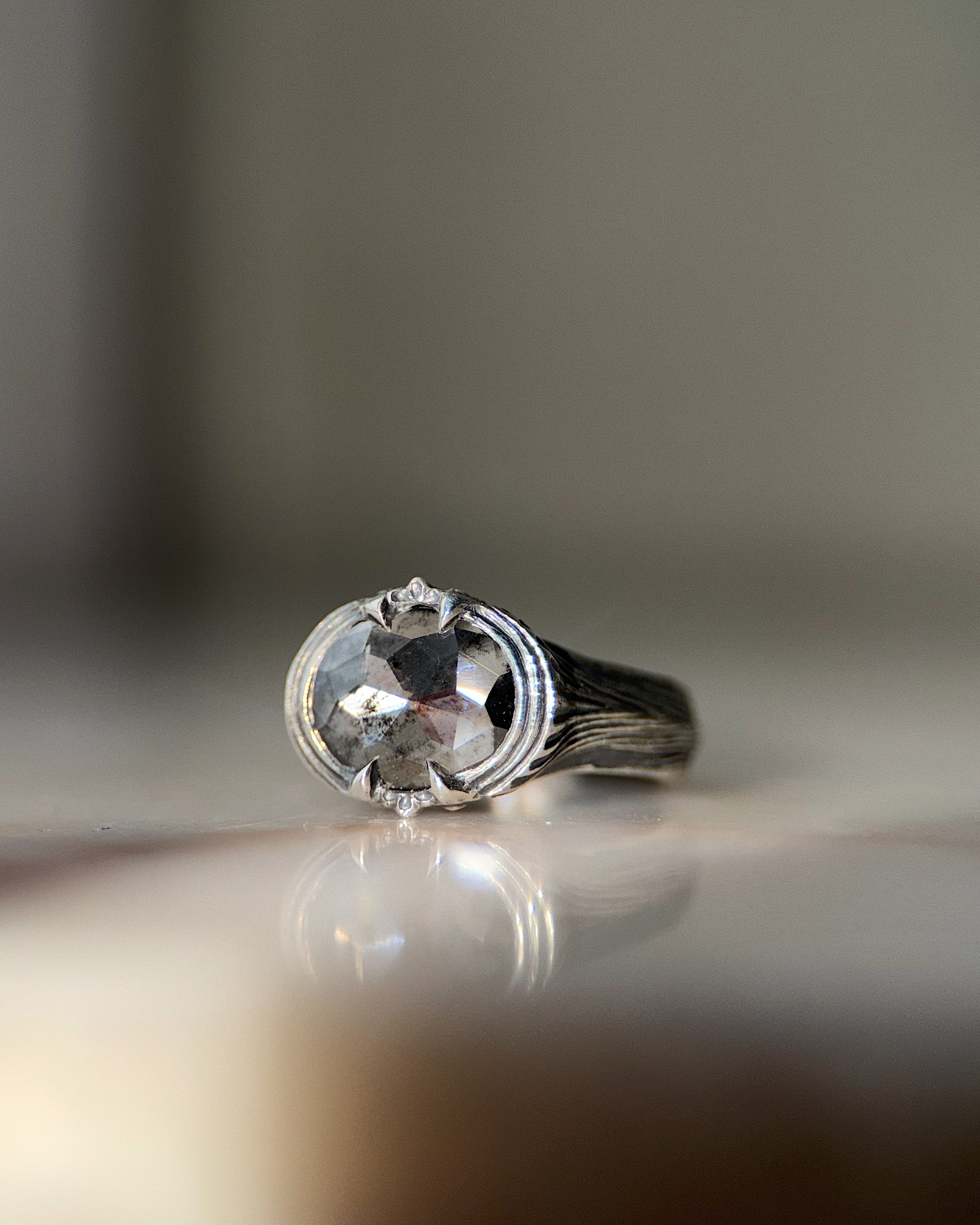 ecclesia pyre ring in sterling silver set with large 9mm wide salt and pepper diamond with pronounced facets