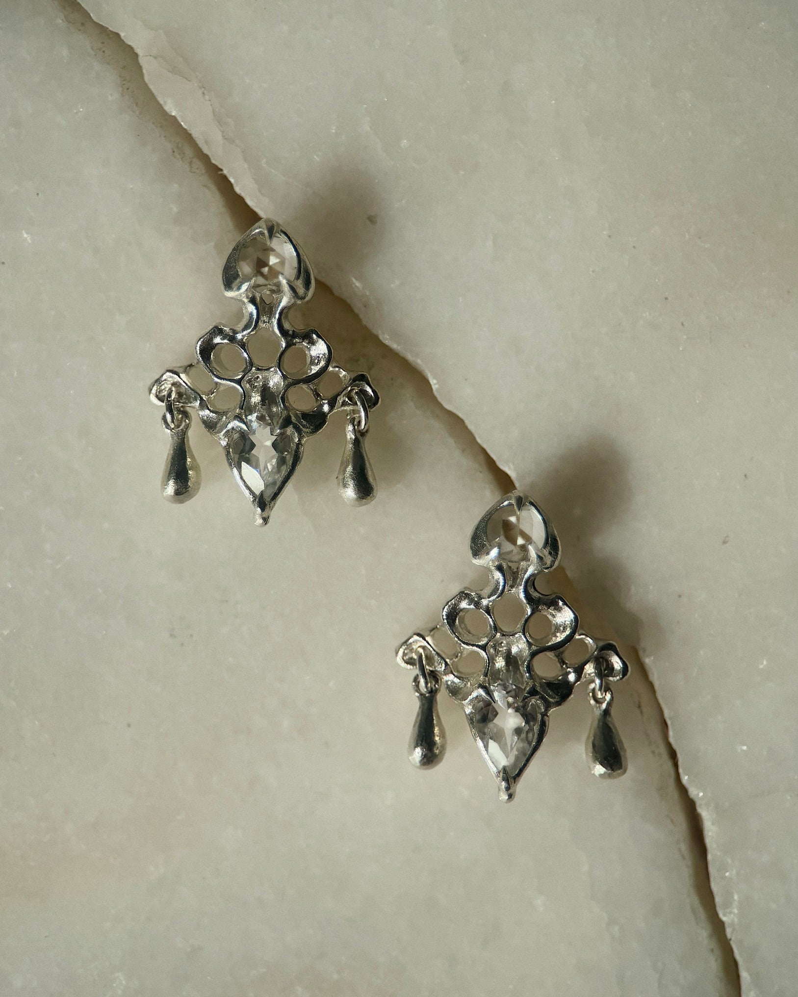 Pair of sterling silver earrings, 2 cm tall, each set with two white topaz gemstones