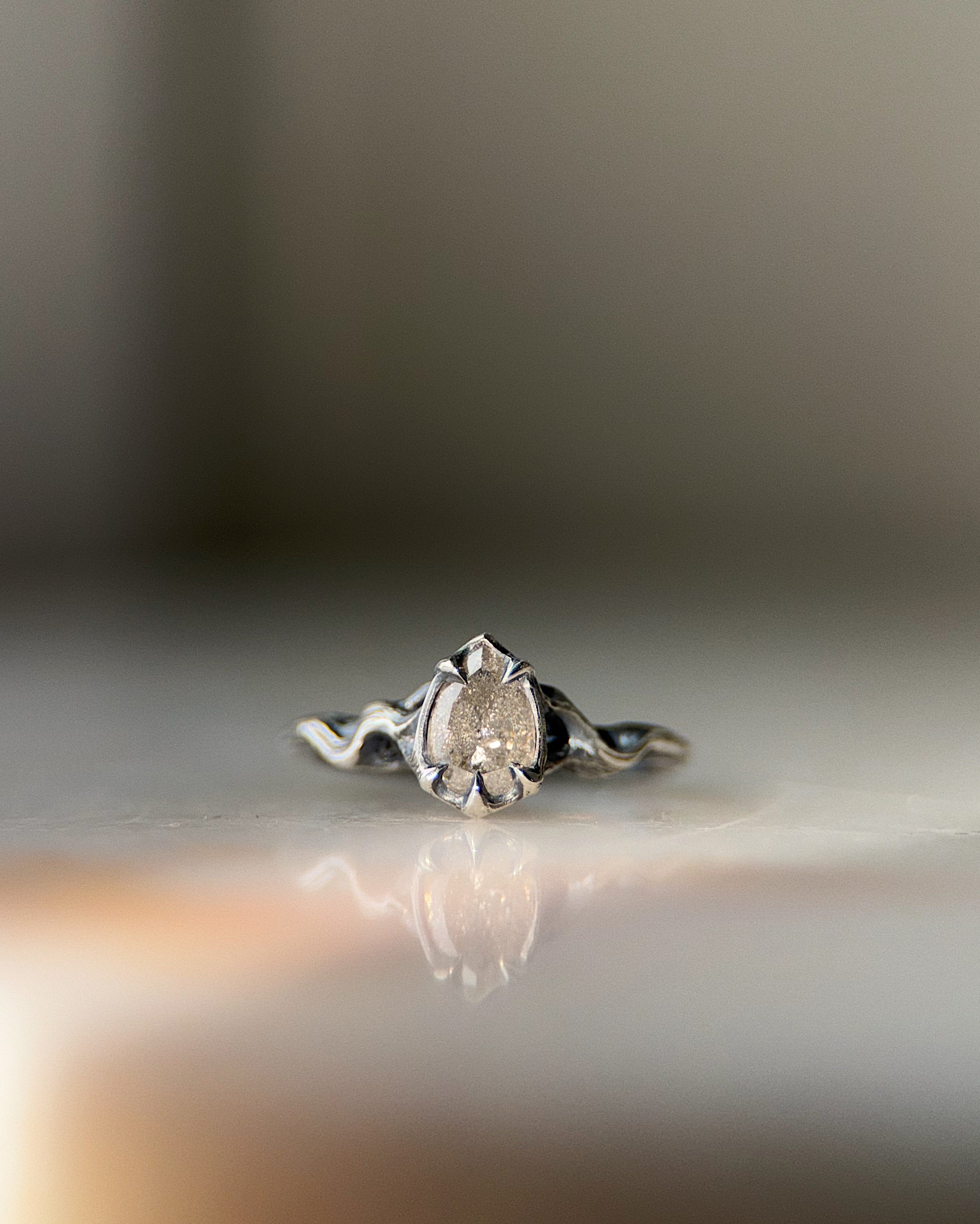 ecclesia pyre ring in sterling silver set with 5 x 7 mm pear shaped lab grown salt and pepper diamond