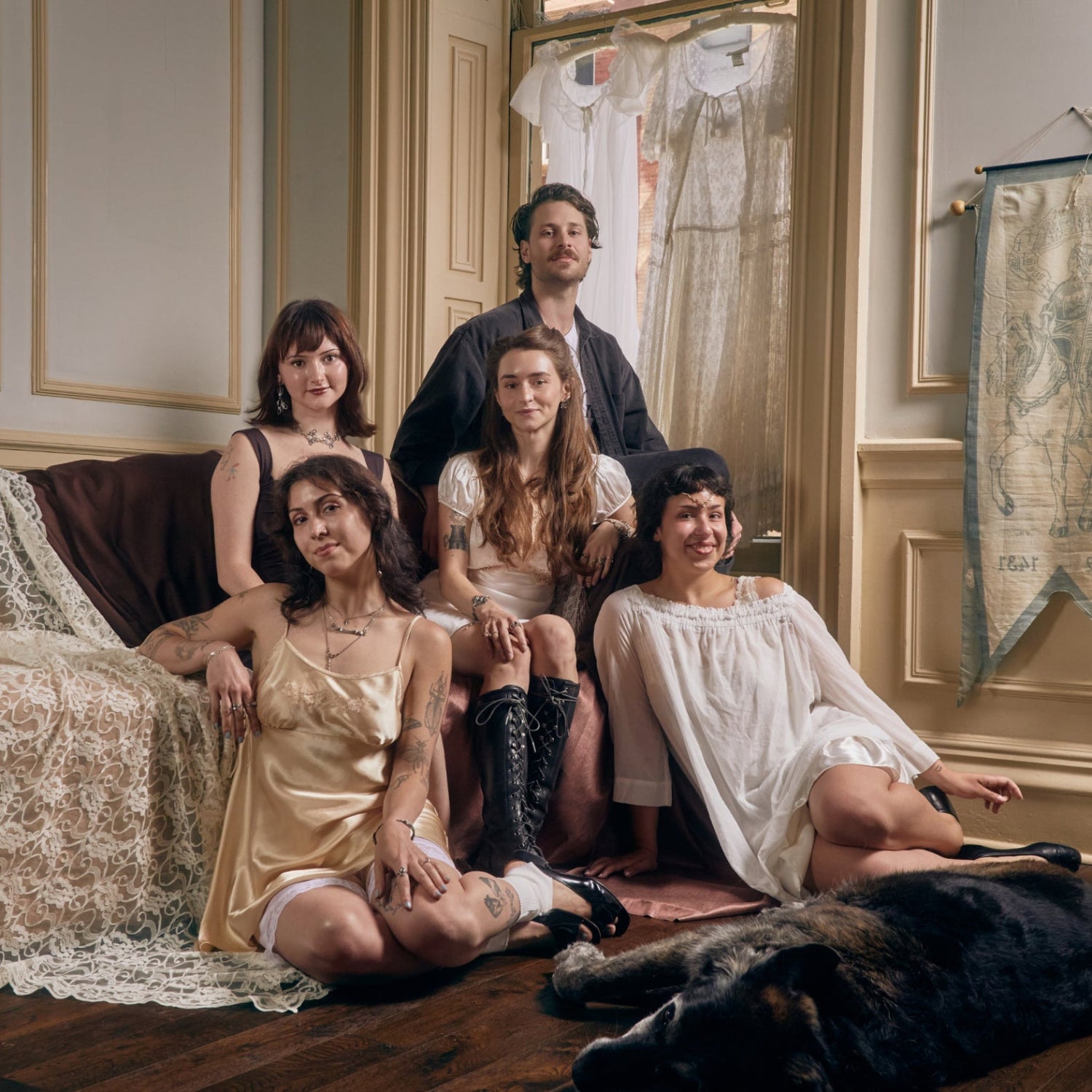 Group of people sitting on a couch in an elegant room with decorative elements.